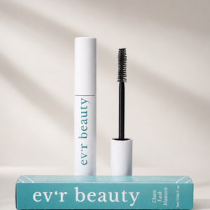 White mascara tube with teal "ev'r beauty" branding standing upright beside an open wand applicator, displayed on a teal rectangular product box reading "ev'r beauty Clean Lash Mascara, 7ml / 0.23 fl oz," against a soft beige background with subtle shadow detail.